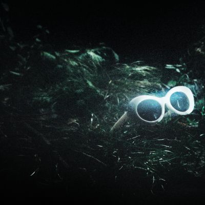White sunglasses on grass at night